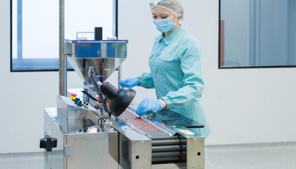 pharmacy-industry-woman-worker-protective-clothing-operating-production-tablets-sterile-working-conditions